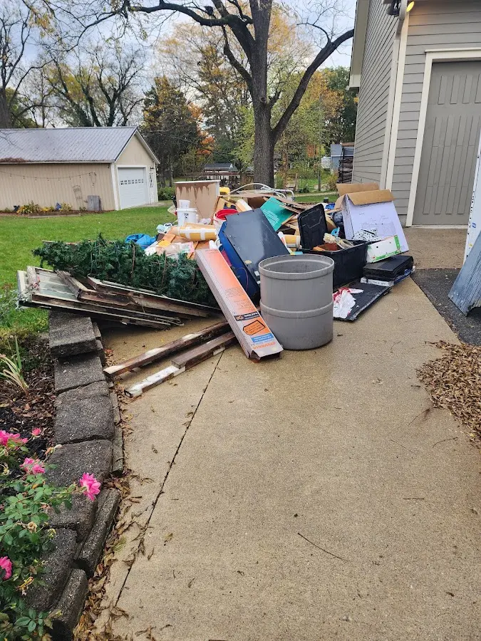 Dumpster being loaded with debris for 12 Yard Dumpster Rental in West Melbourne